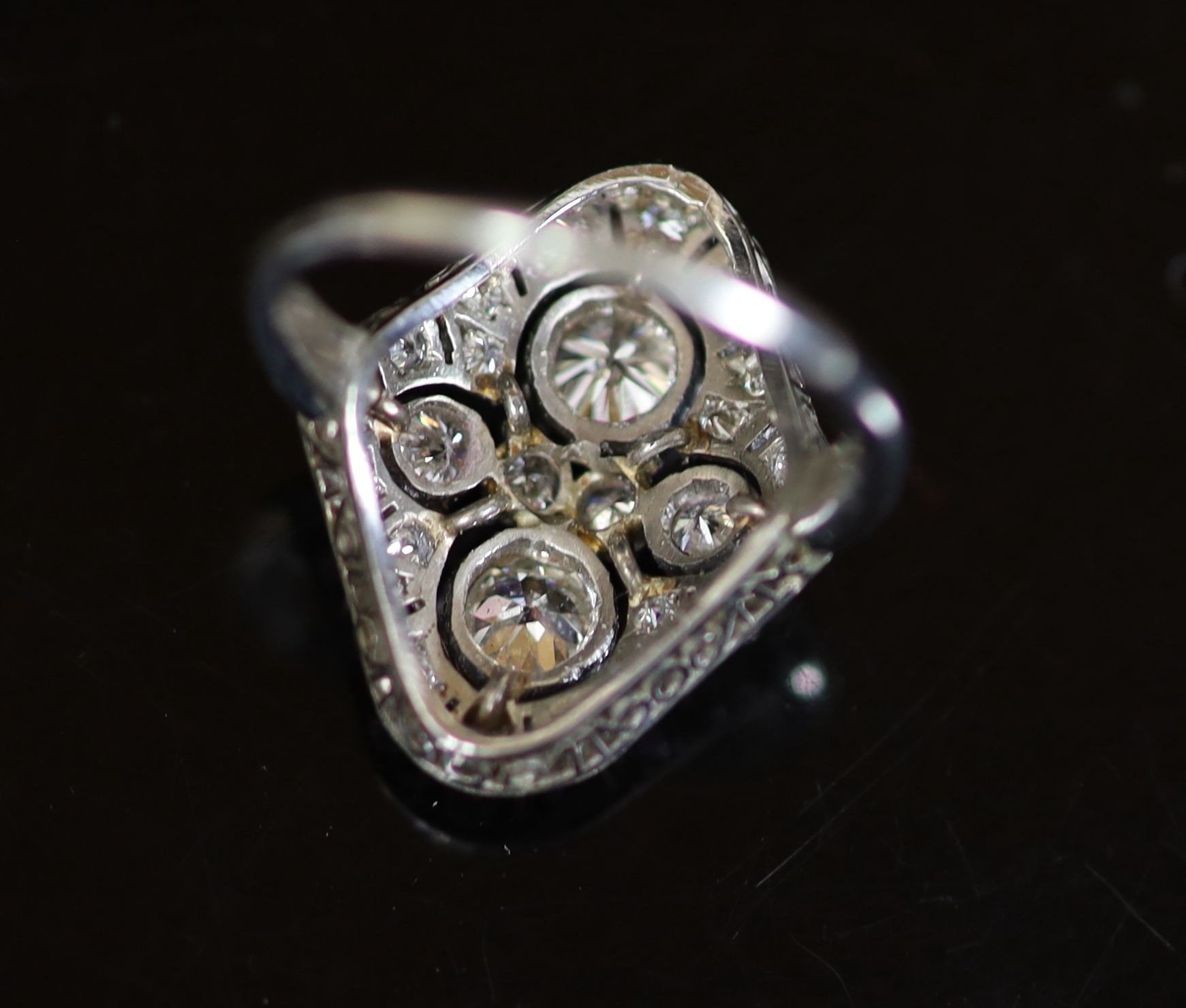 A 1930's/1940's platinum and millegrain set diamond cluster dress ring